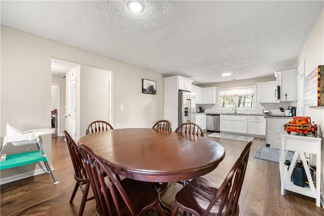 a dining room with furniture and wooden floor
