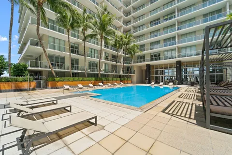 a view of a swimming pool with a lounge chairs