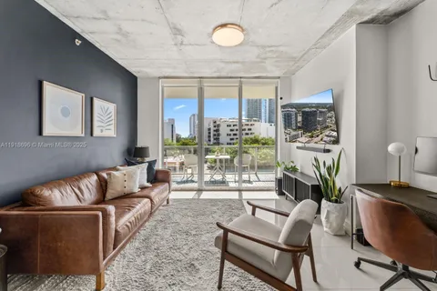 a living room with furniture a lamp and a potted plant