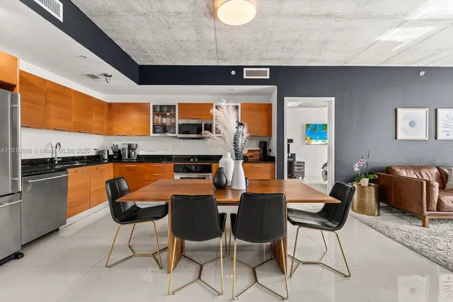 a dining room with furniture and a kitchen view