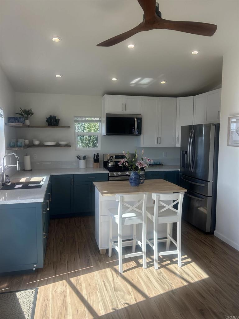 337-2 South Barnwell Street Oceanside, CA 92054 - Photo 11 of 21 a kitchen with stainless steel appliances granite countertop a refrigerator a sink a stove a microwave and wooden cabinets