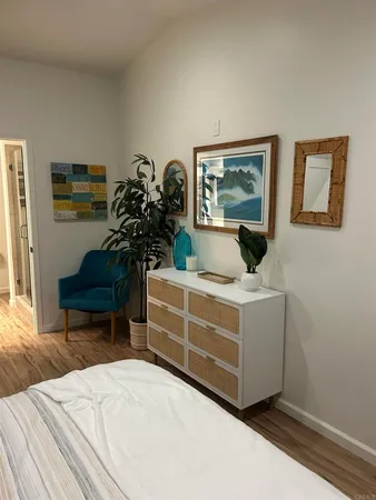 a bed room with a bed and a chair