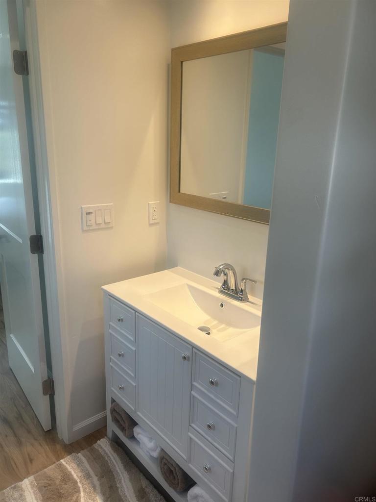 337-2 South Barnwell Street Oceanside, CA 92054 - Photo 21 of 21 a bathroom with a granite countertop sink and a mirror