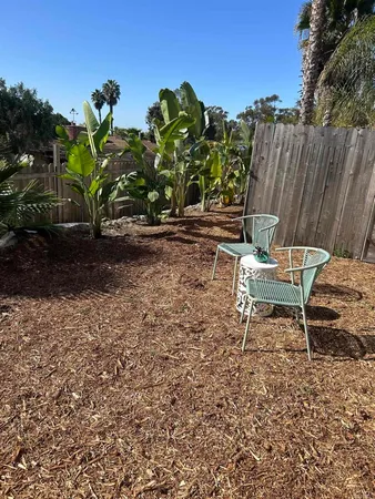 a lawn chairs sitting in a backyard