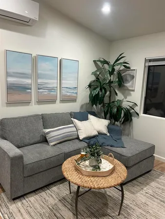 a living room with furniture and wooden floor