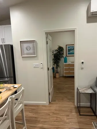 a view of a workspace with furniture and wooden floor