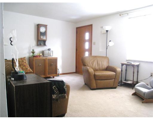 7808 Noblestown Road McDonald, PA 15057 - Photo 2 of 14 Living Room. Living Room features carpeting and an exposed brick wall.