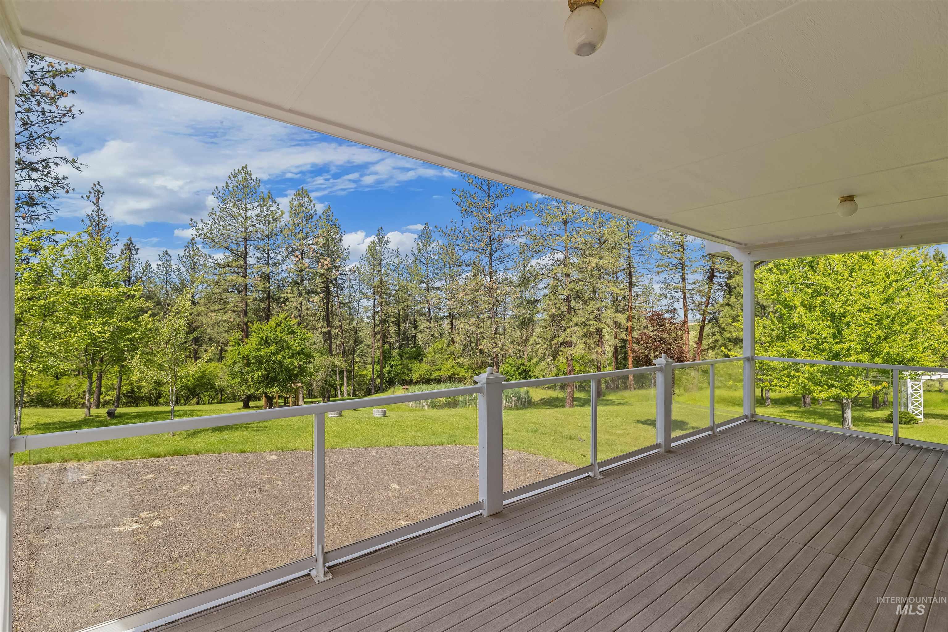 743 Wall Crk Road Stites, ID 83552 - Photo 24 of 48 Covered deck featuring wood-finish flooring, white railing with glass panels, and recessed lighting