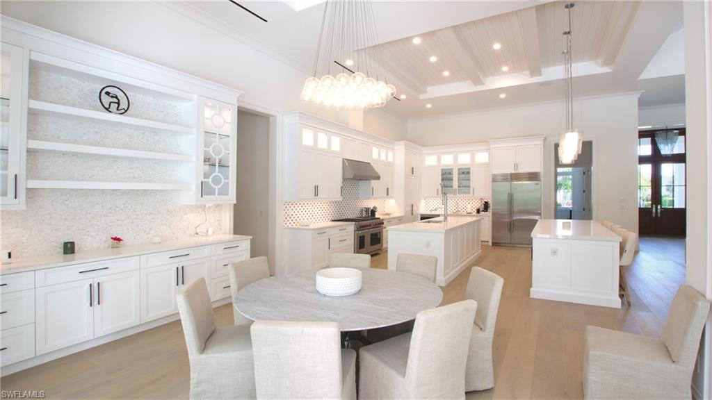 700 Wedge Drive Naples, FL 34103 - Photo 8 of 19 a large kitchen with a table and chairs