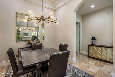 a dining room with furniture and a chandelier