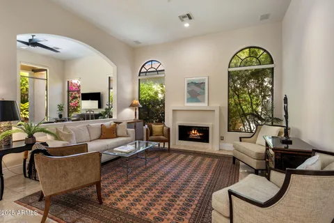 a living room with furniture fireplace and window