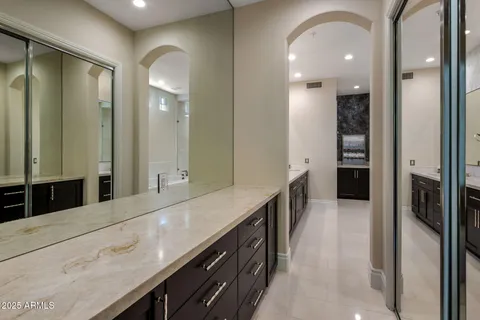 a bathroom with a double vanity sink and a mirror