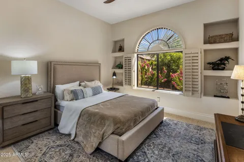 a bedroom with a large bed and a large window