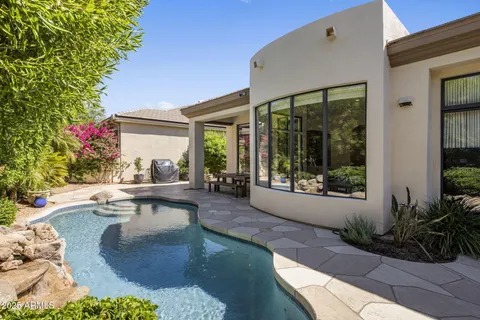 a view of a swimming pool with lounge chair