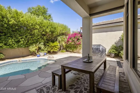 a view of a patio with table and chairs and potted plants