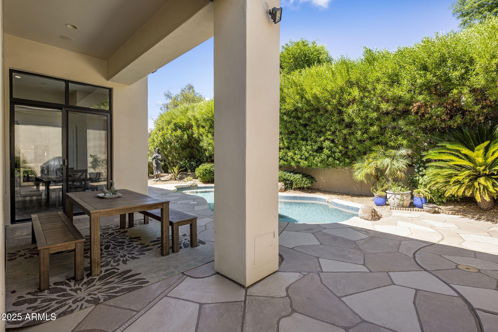 8216 East Angel Spirit Drive Scottsdale, AZ 85255 - Photo 26 of 29 a view of a patio with table and chairs and potted plants