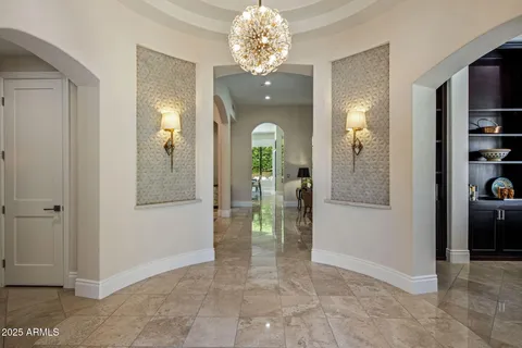 wooden floor and hallway with chandelier