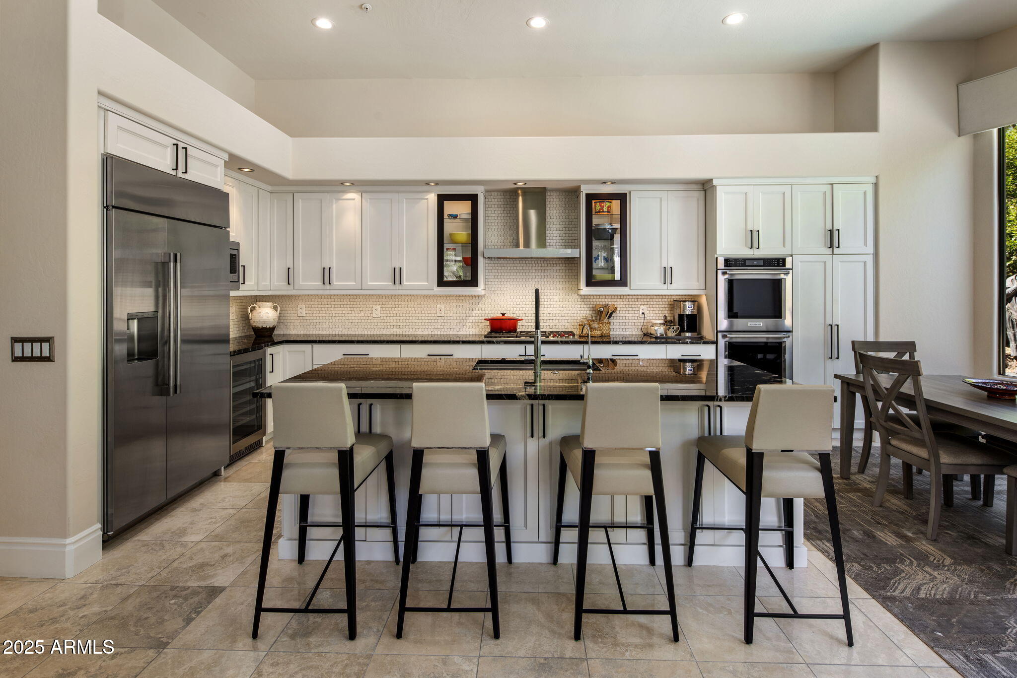 8216 East Angel Spirit Drive Scottsdale, AZ 85255 - Photo 5 of 29 a kitchen with stainless steel appliances kitchen island granite countertop a table and chairs
