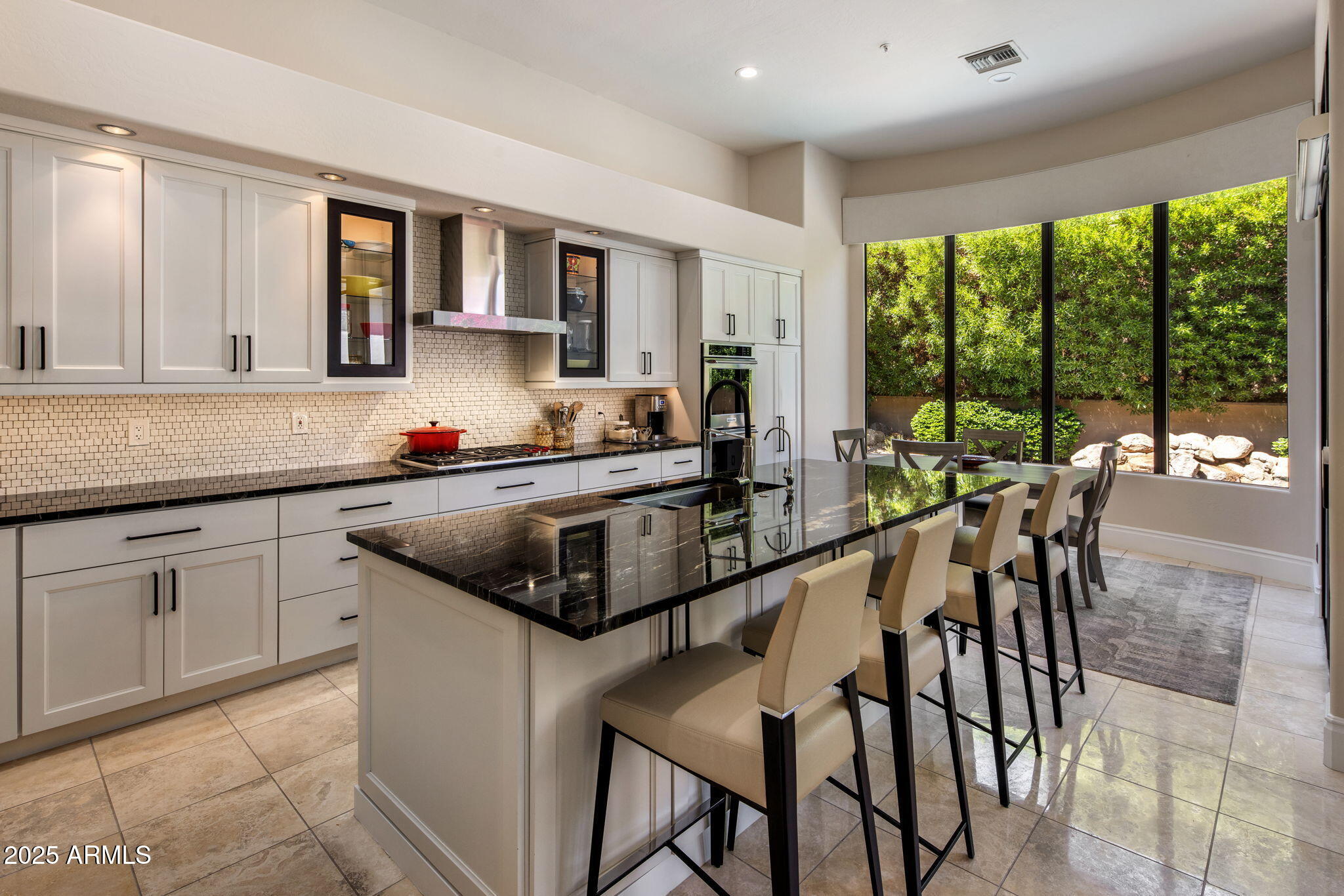 8216 East Angel Spirit Drive Scottsdale, AZ 85255 - Photo 6 of 29 a kitchen with a stove a sink and white cabinets
