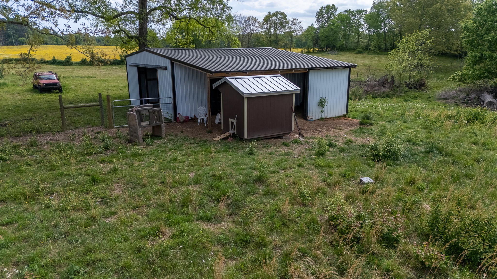 521 Revilo Road Leoma, TN 38468 - Photo 9 of 14 a view of a barn house in the middle of a yard