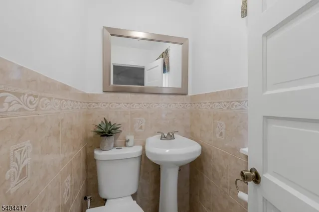 a bathroom with a sink toilet and mirror