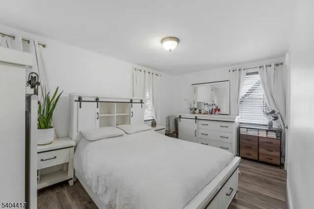 a bedroom with a bed and a flat tv screen