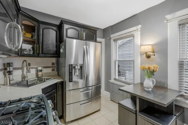 a kitchen with a refrigerator and a sink