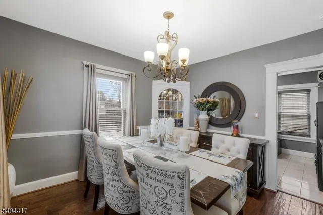 a view of a dining room with furniture and chandelier