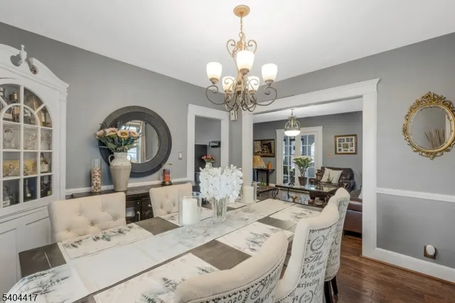 a view of a dining room with furniture and chandelier