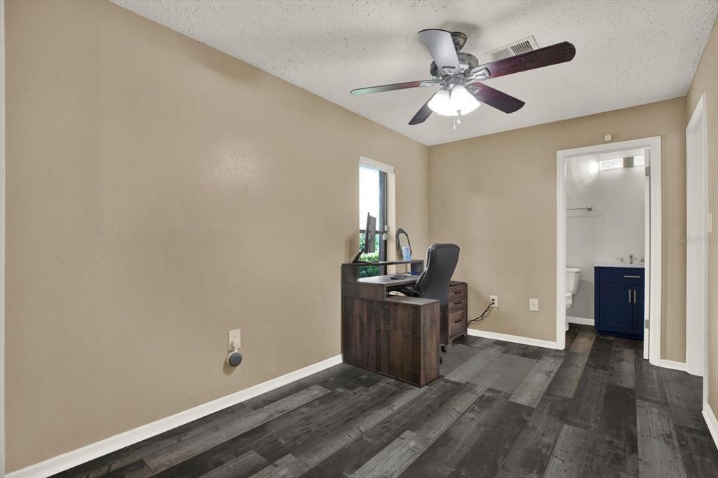 7487 River Country Drive Weeki Wachee, FL 34607 - Photo 36 of 53 wooden floor in an empty room with a window