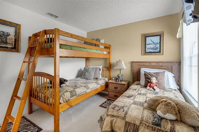 a bedroom with bed and a window