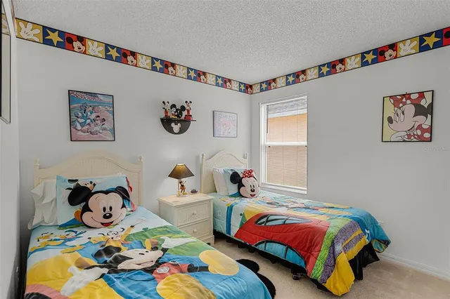 a bedroom with a bed and a table in it