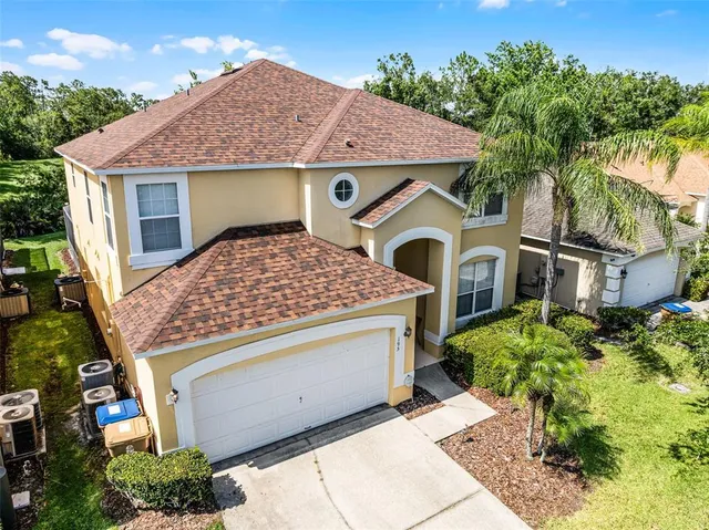 an aerial view of a city with lots of residential buildings ocean and mountain view in back