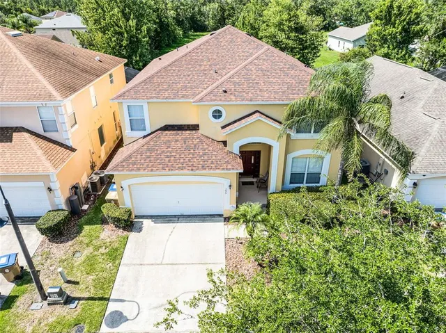 an aerial view of a house with a yard