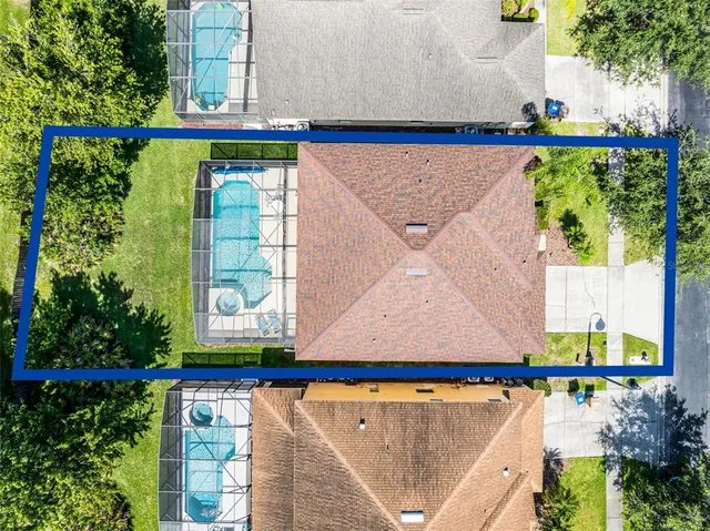 an aerial view of a city with lots of residential buildings ocean and mountain view in back