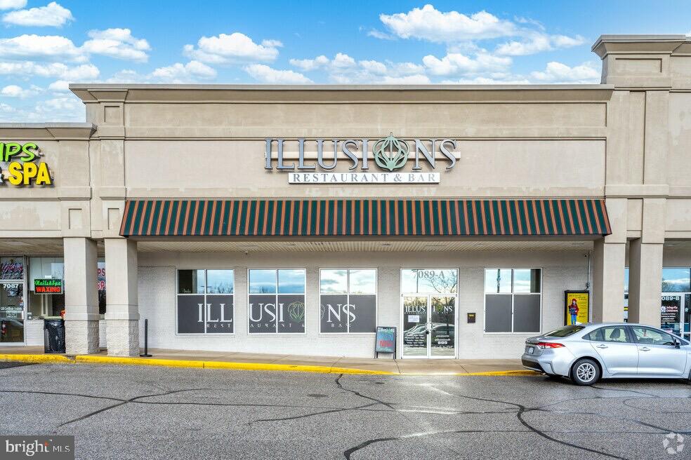 P298-p263 Nursery Road Linthicum Heights, MD 21090 - Photo 11 of 12 a view of a swimming pool with an outdoor space and seating area