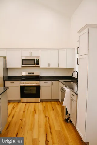 a kitchen with a sink appliances and cabinets