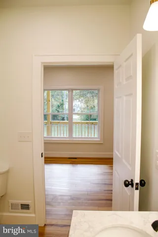 a view of a kitchen and an empty room