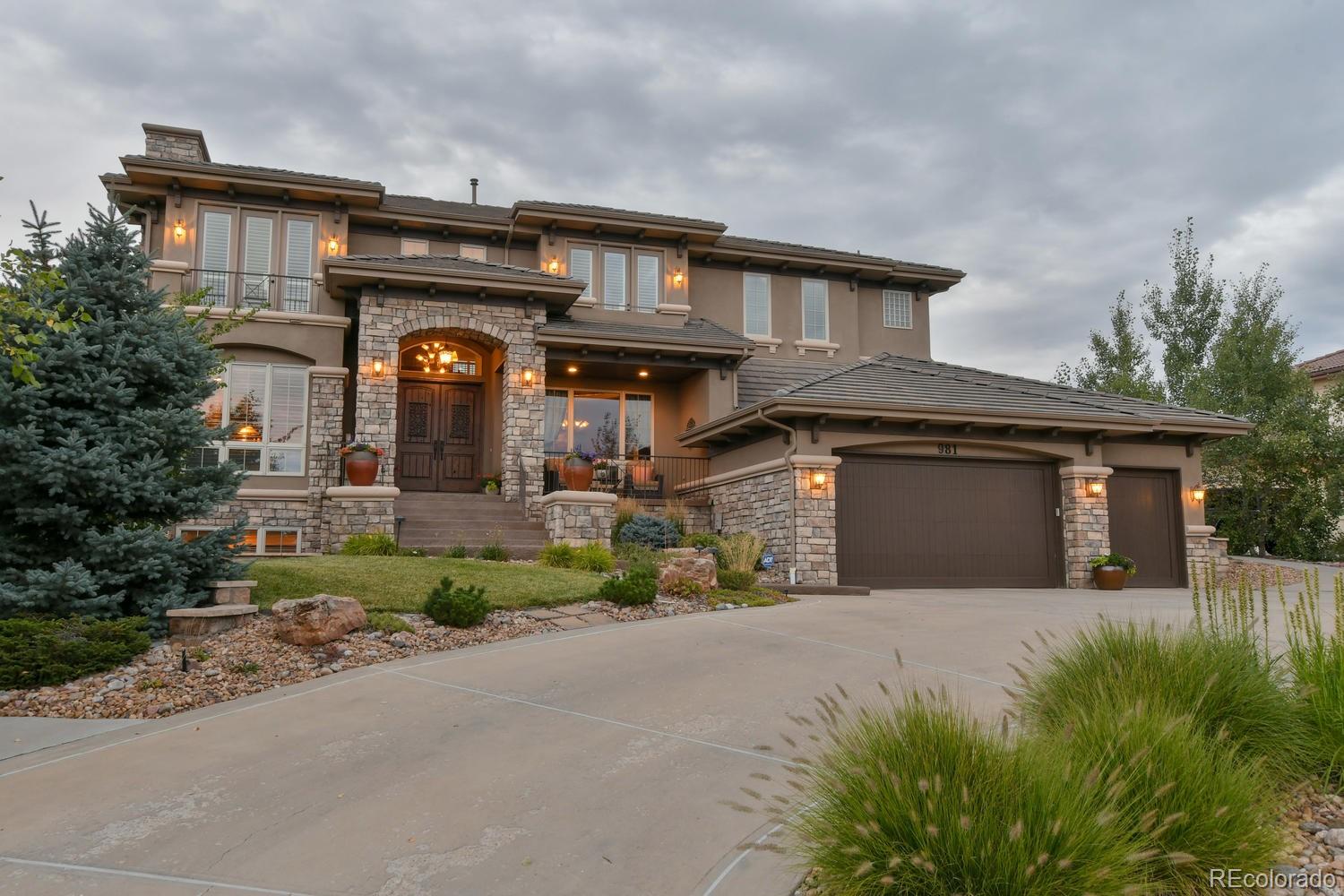 a front view of a house with a yard and garage