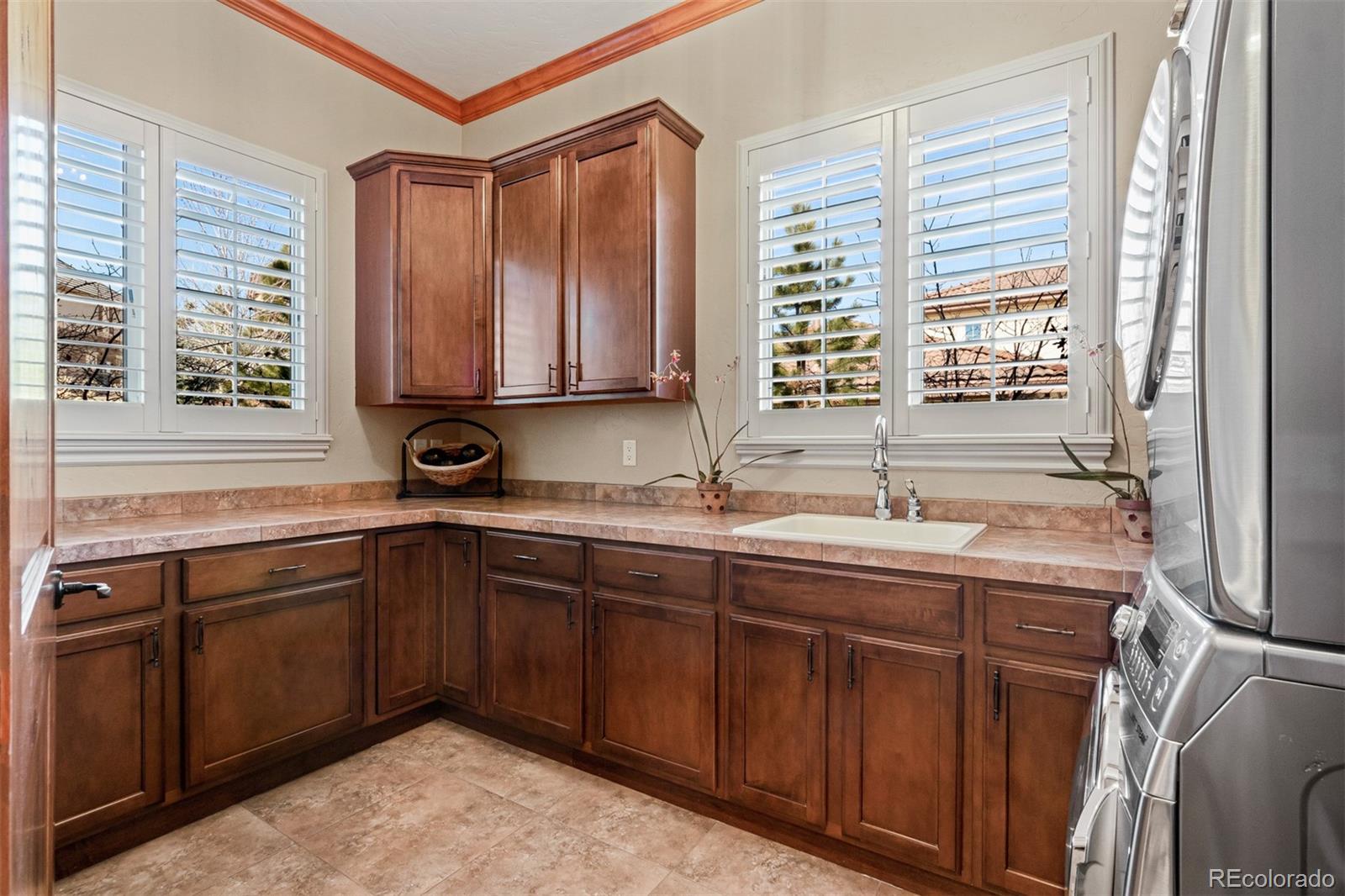 981 Buffalo Ridge Road Castle Pines, CO 80108 - Photo 13 of 39 a kitchen with a sink stove and cabinets