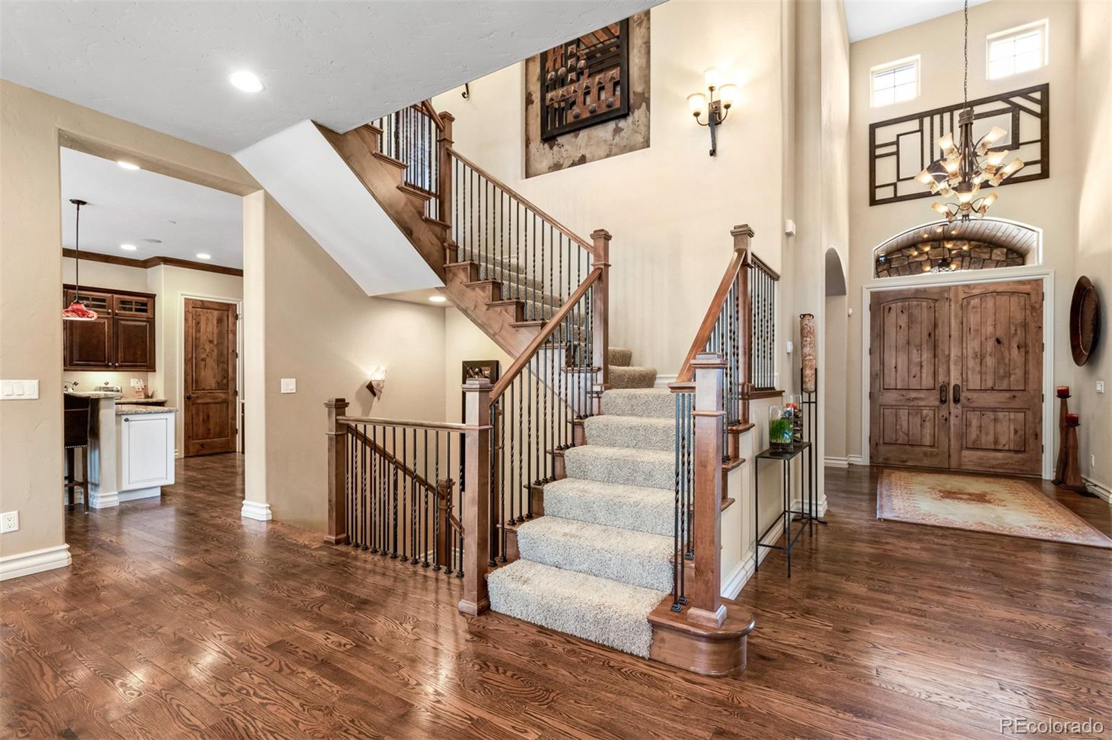 981 Buffalo Ridge Road Castle Pines, CO 80108 - Photo 14 of 39 a view of entryway and hall with wooden floor