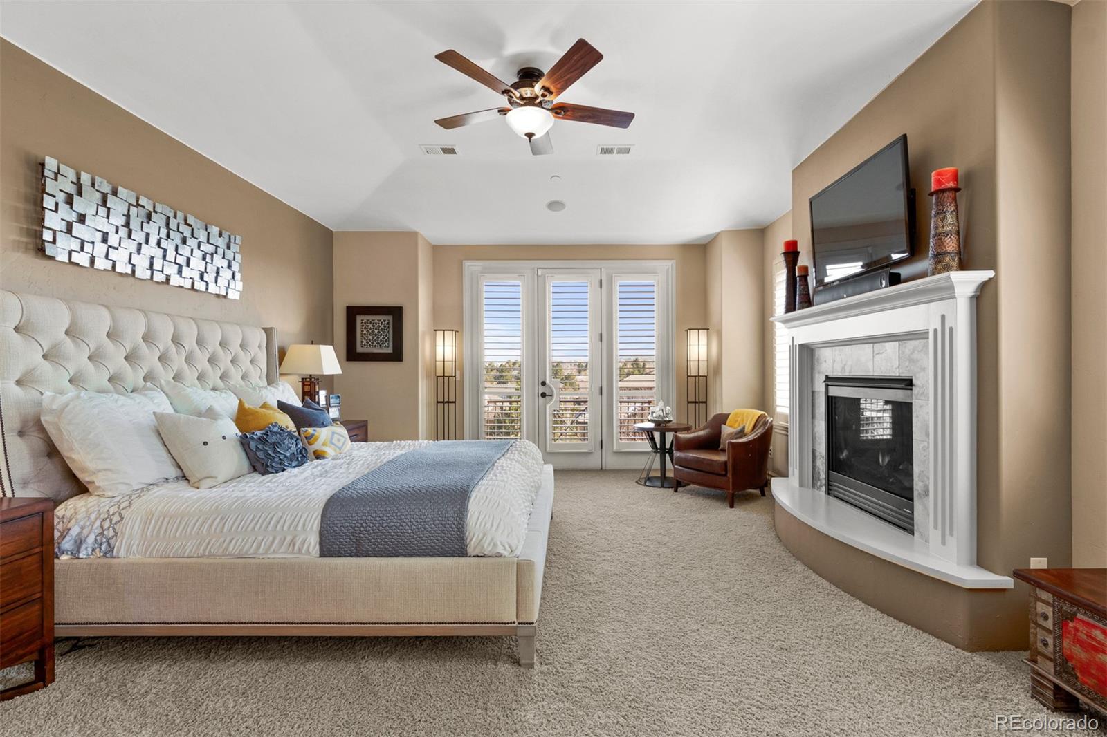 981 Buffalo Ridge Road Castle Pines, CO 80108 - Photo 17 of 39 a living room with furniture a fireplace and a flat screen tv
