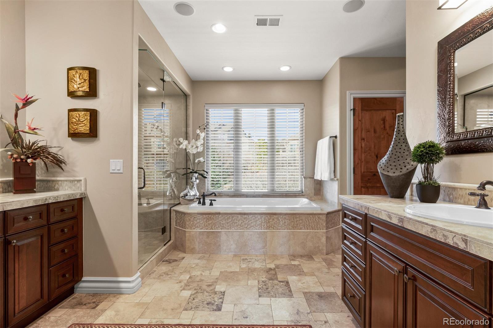 981 Buffalo Ridge Road Castle Pines, CO 80108 - Photo 19 of 39 a spacious bathroom with a tub sink and mirror