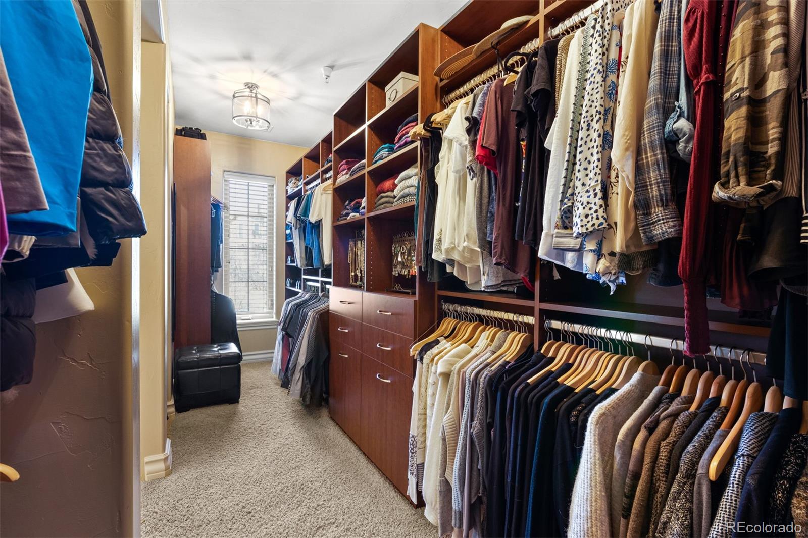 981 Buffalo Ridge Road Castle Pines, CO 80108 - Photo 21 of 39 a view of walk in closet with clothes and shoes