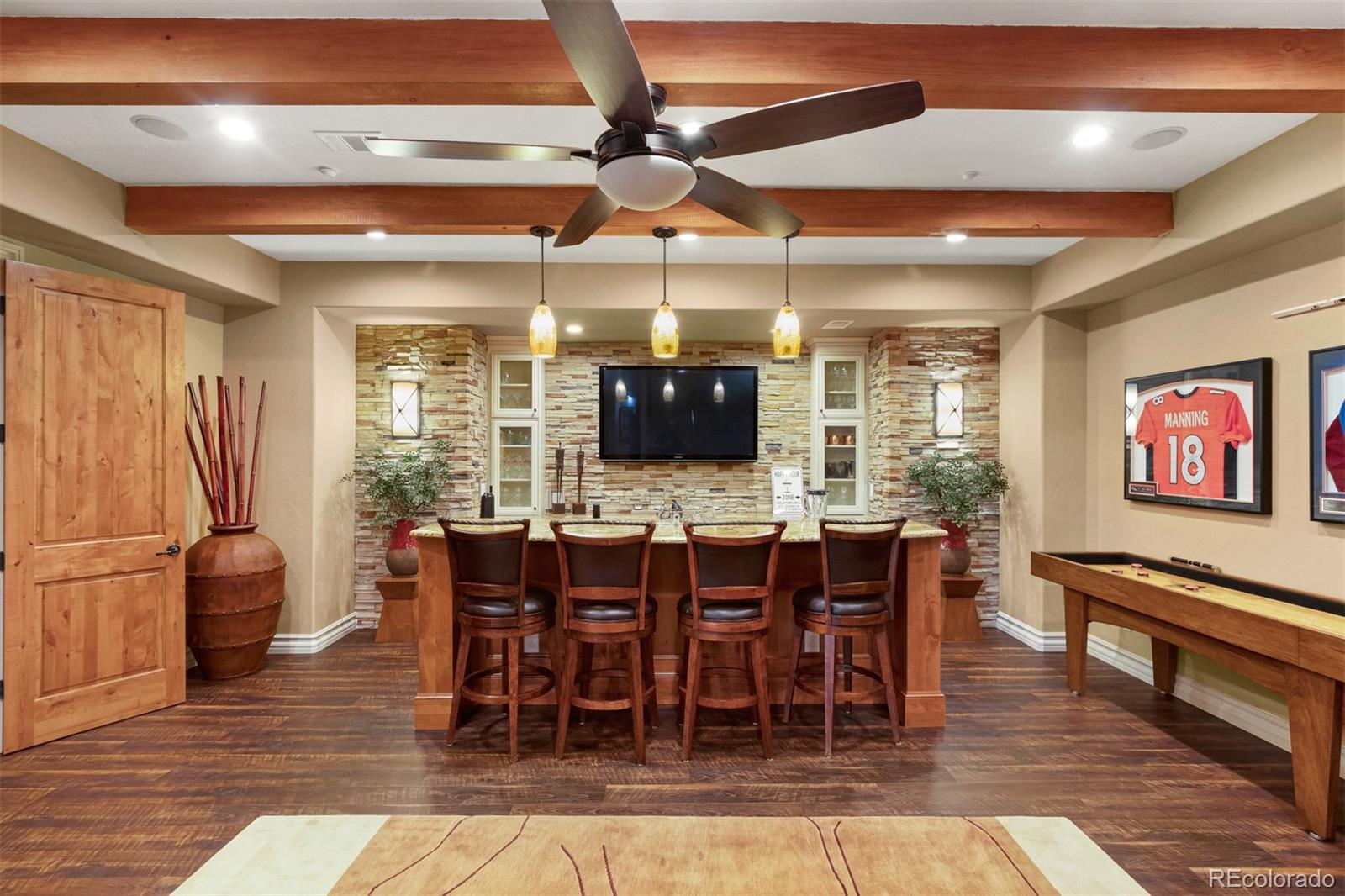 981 Buffalo Ridge Road Castle Pines, CO 80108 - Photo 24 of 39 a view of a dining room with furniture window and wooden floor