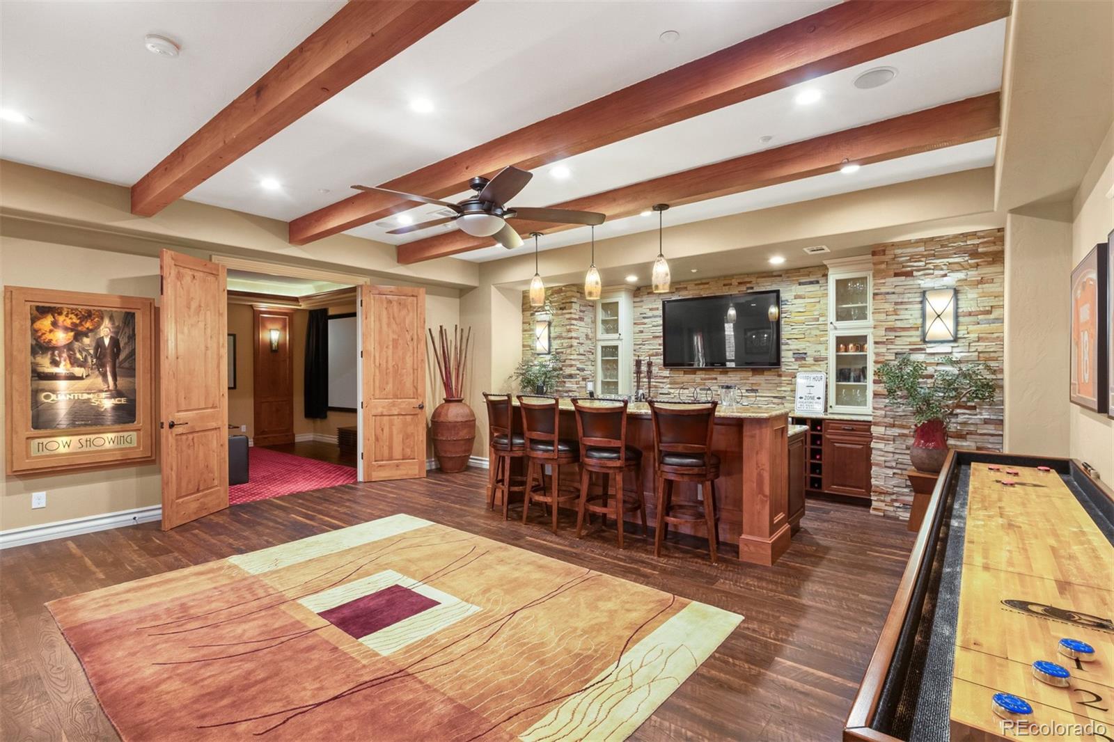 981 Buffalo Ridge Road Castle Pines, CO 80108 - Photo 25 of 39 a living room with dining room and wooden floor