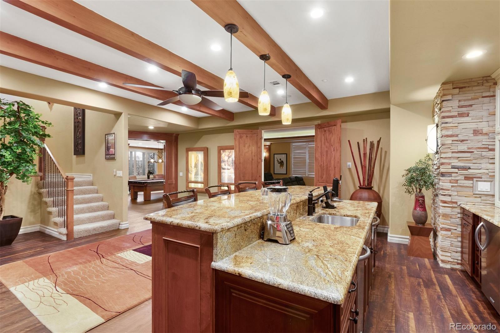 981 Buffalo Ridge Road Castle Pines, CO 80108 - Photo 26 of 39 a view of a dining room and hall with wooden floor