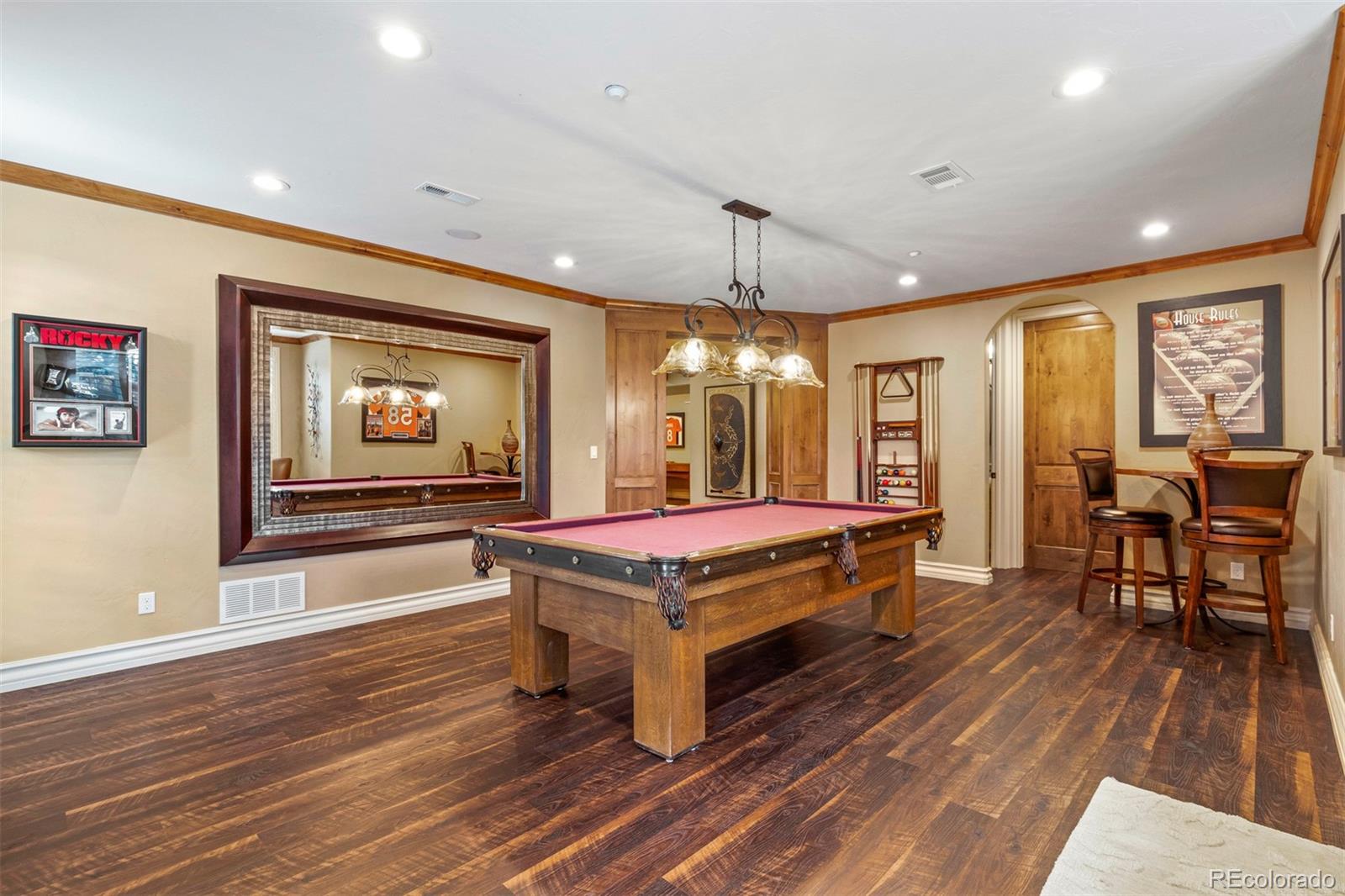 981 Buffalo Ridge Road Castle Pines, CO 80108 - Photo 28 of 39 a living room with furniture a flat screen tv and wooden floor