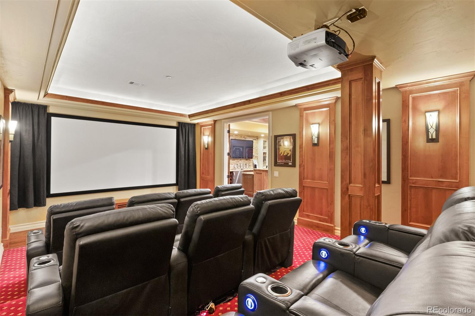 981 Buffalo Ridge Road Castle Pines, CO 80108 - Photo 29 of 39 a media room with lots of chairs and a projector screen