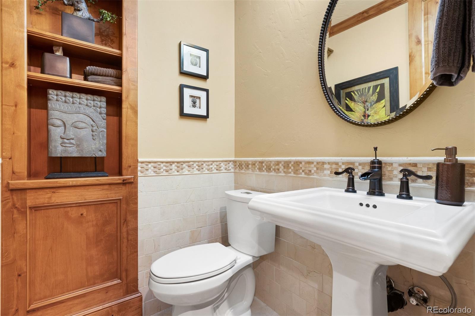 981 Buffalo Ridge Road Castle Pines, CO 80108 - Photo 30 of 39 a bathroom with a sink and a mirror